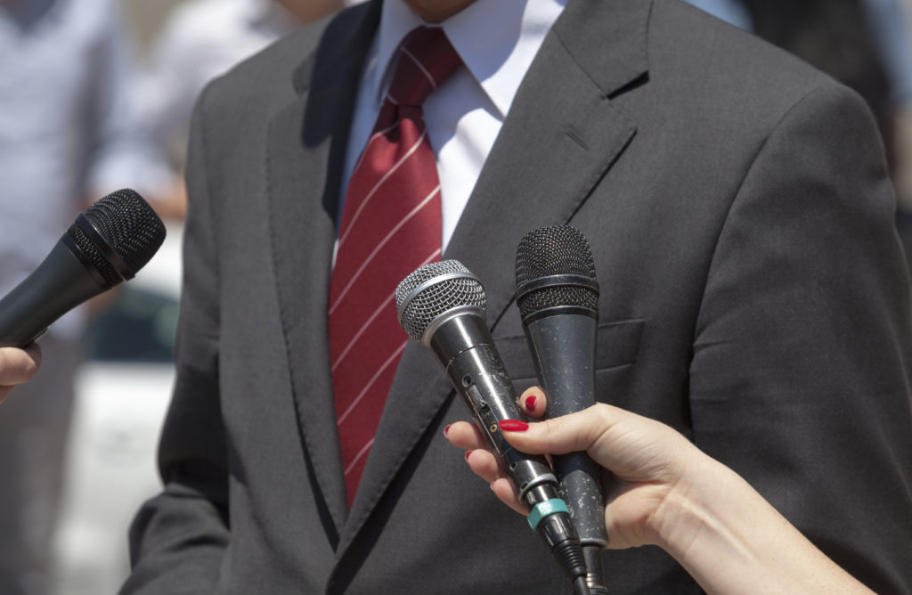 Journalists making interview with businessperson or politician