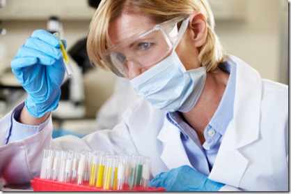 Female Scientist Studying Test Tube In Laboratory