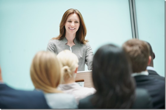 Beautiful female speaker in conference