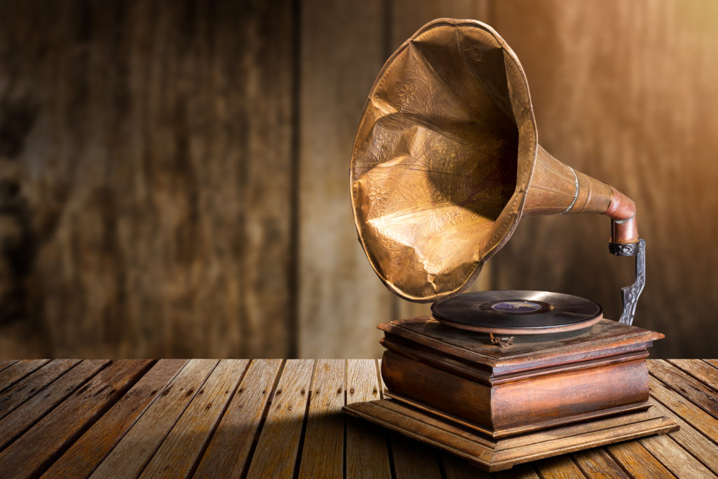 Antique gramophone vinyl record player on wooden table