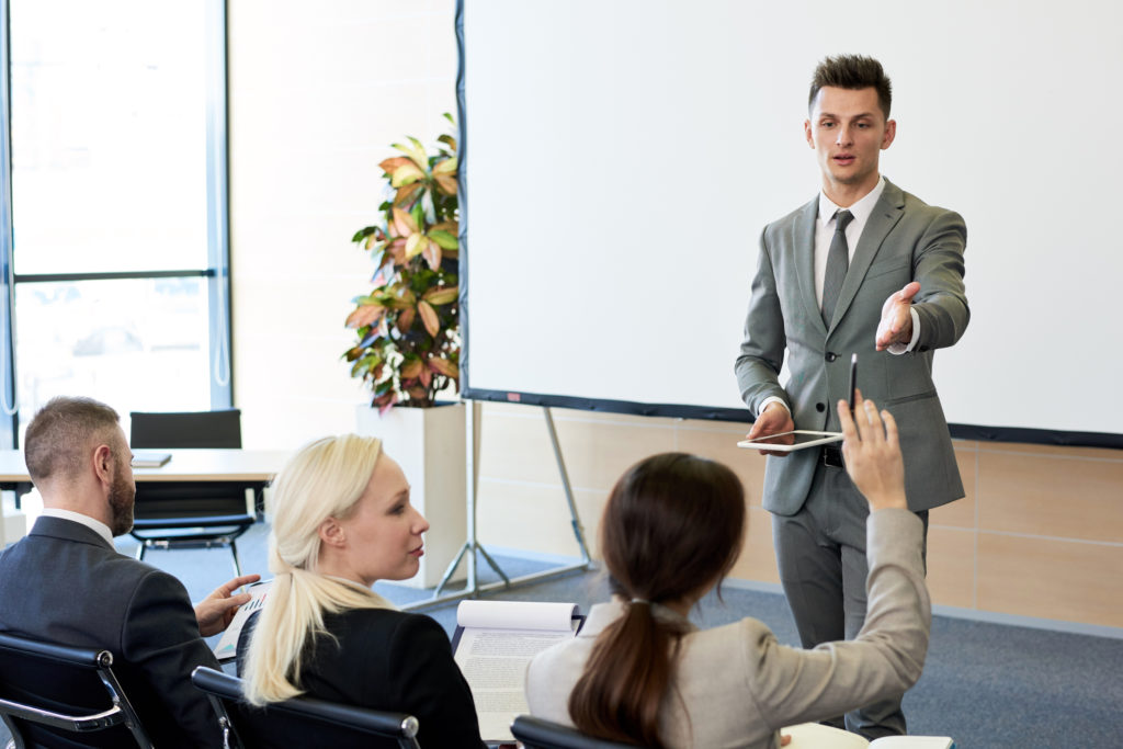 Business man answers questions from audience