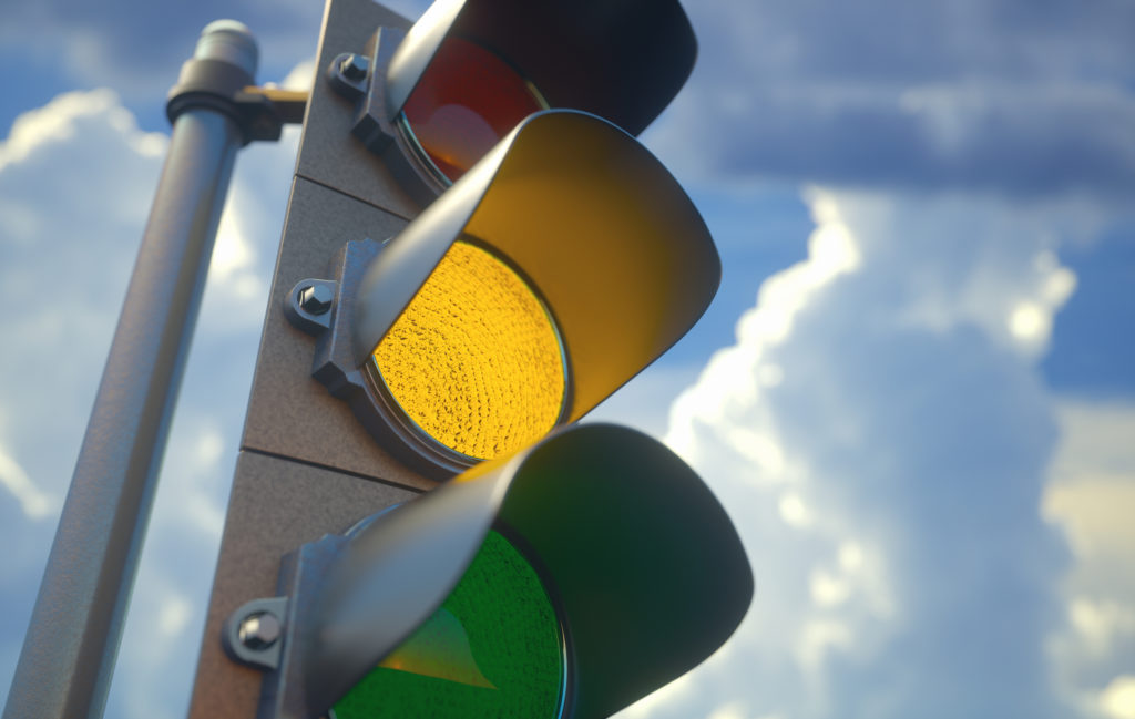 Traffic light with yellow light on