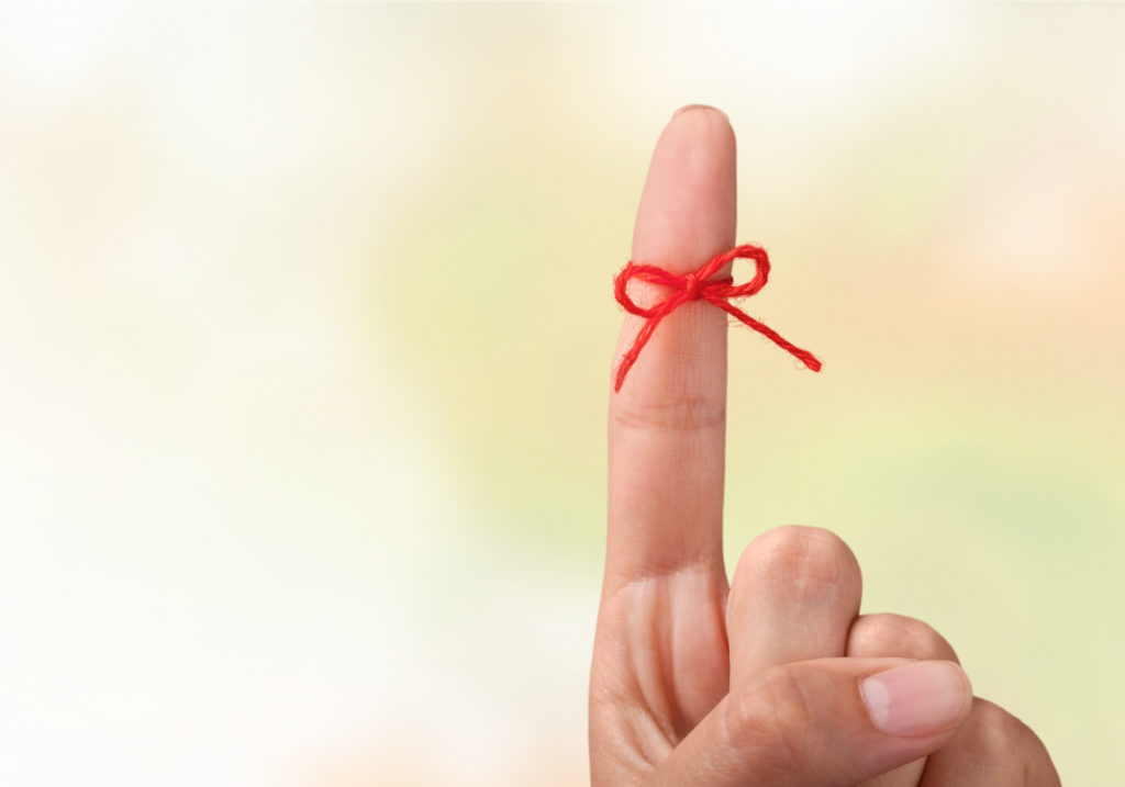 Rope bow on finger pointing up on background