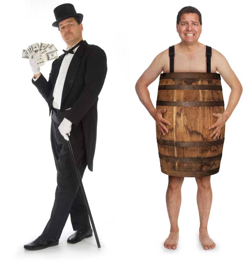 Man in tuxedo, top hat and cane fanning himself with money while next to man in a barrel.