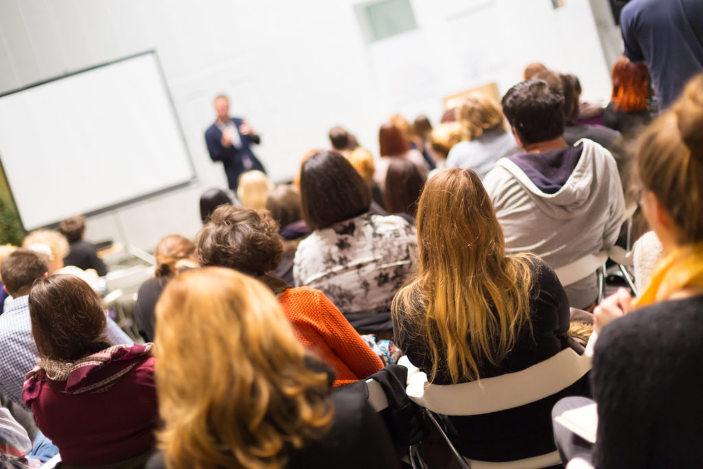 A speaker is talking to a large audience