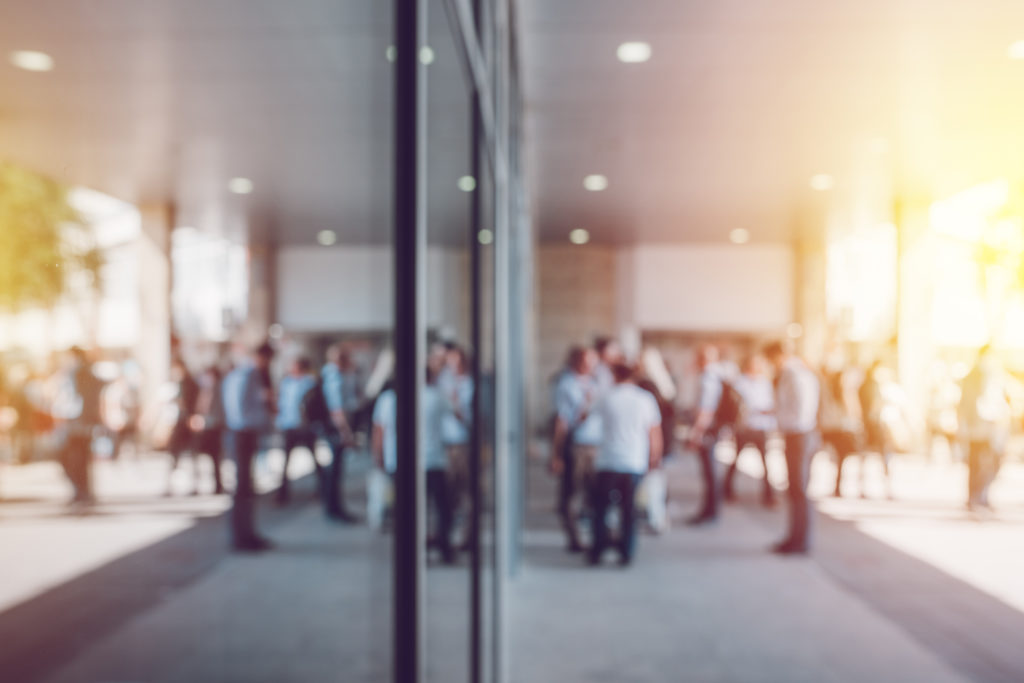 Business people standing outside a builidng in a blur