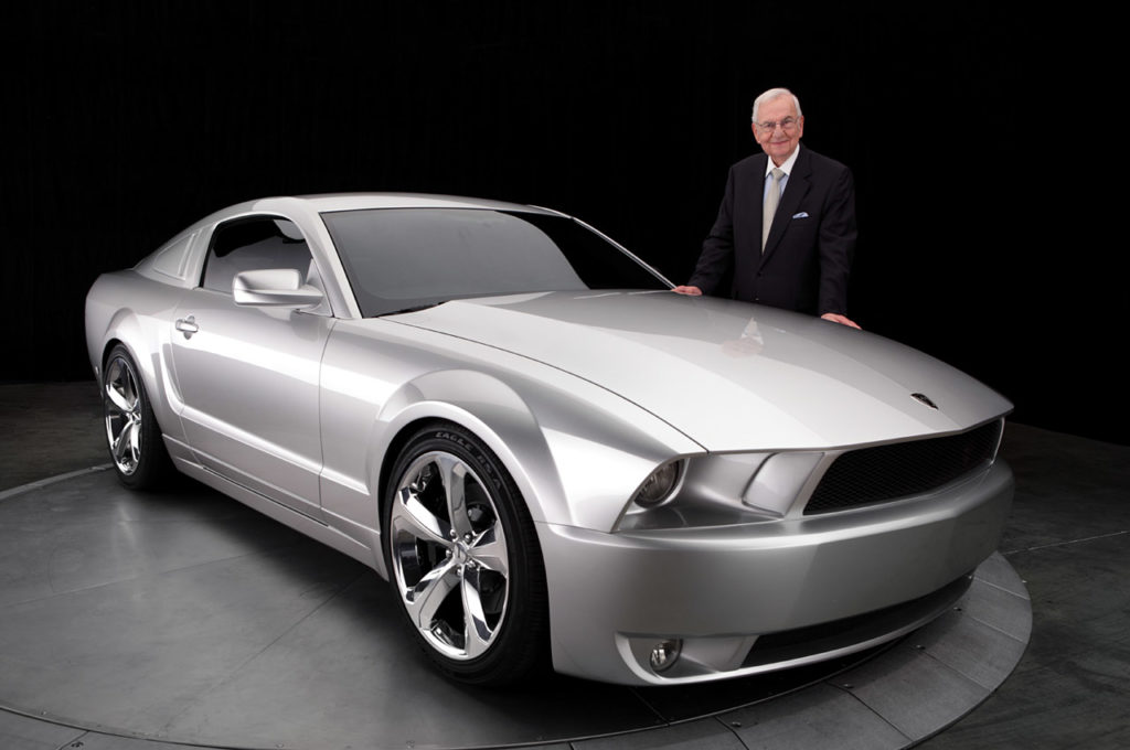 Lee Iacocca stands next to a 2009 special edition Mustang