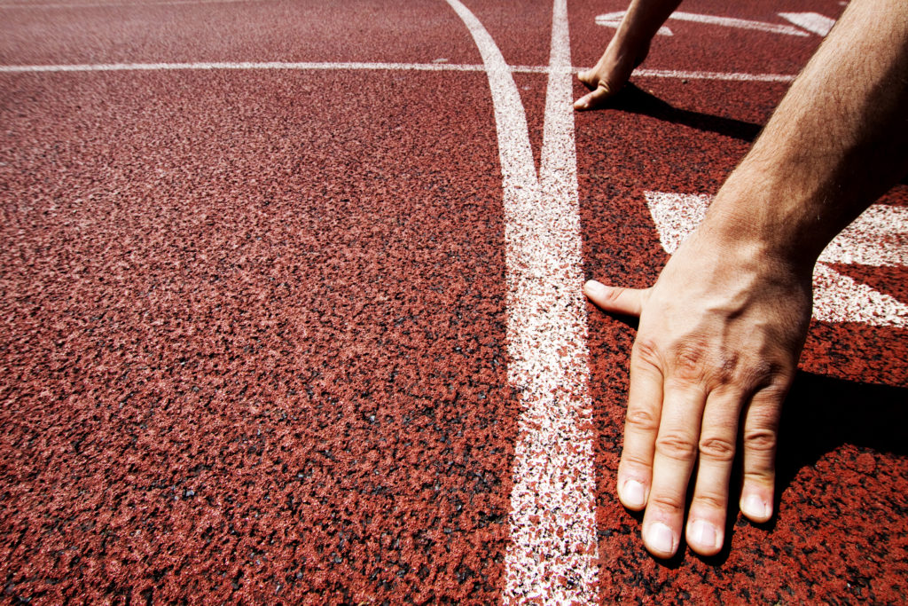 A runners hands on the starting line