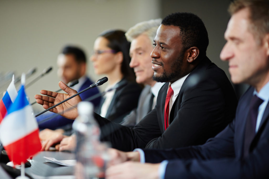 Young African-american politician explaining his opinion to audience during conference