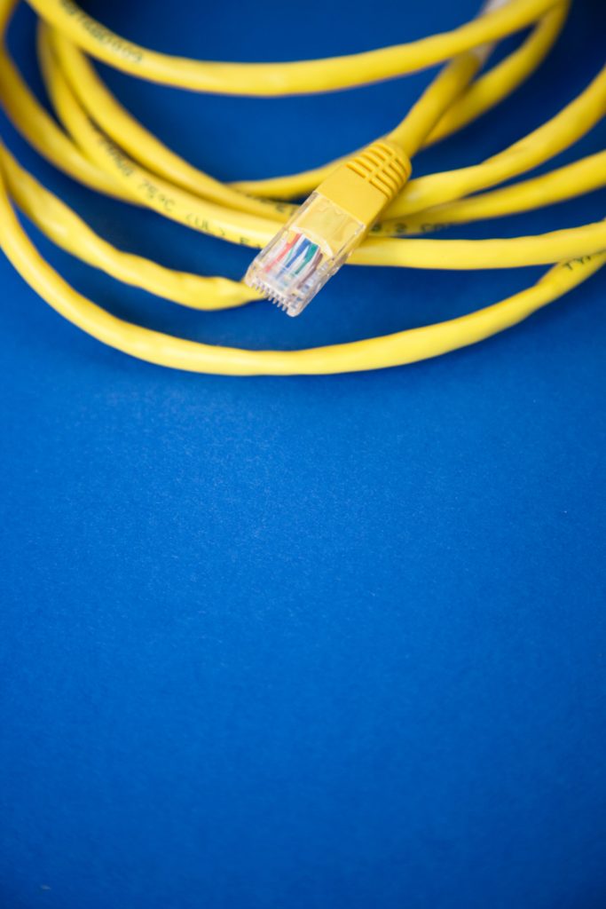 Yellow DSL wire on blue background by Markus Spiske on Unsplash